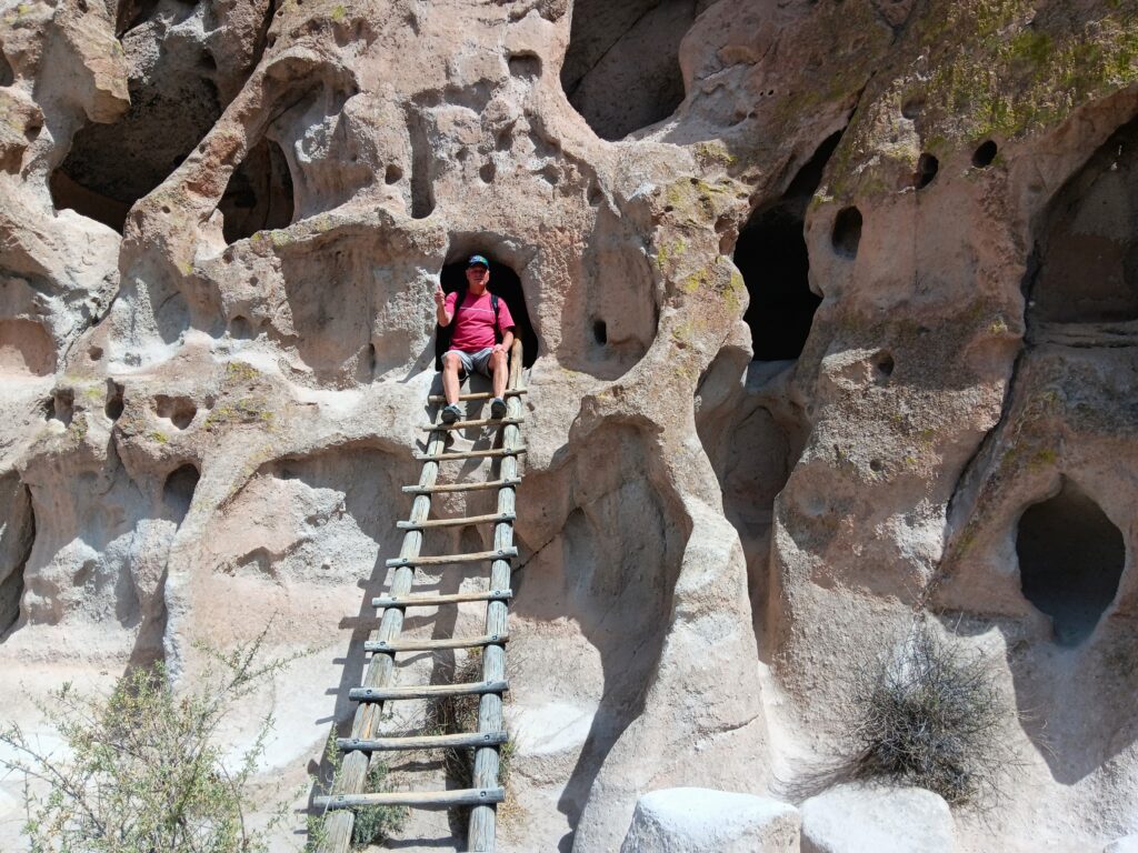 Steve at top of ladder to one of the many cavates at Bandelier National Monument