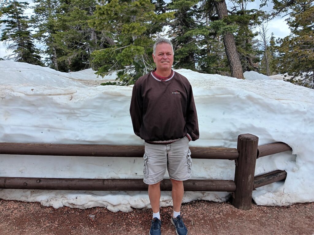 Steve with snow behind at Rainbow Point, Bryce Canyon National Park 