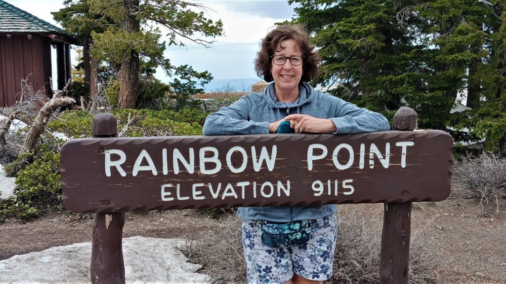 Karen at Rainbow Point sign, Bryce Canyon National Park 