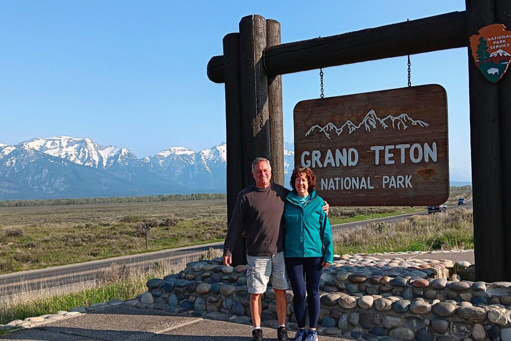 Karen and Steve at entrance sign to Grand Teton National Park