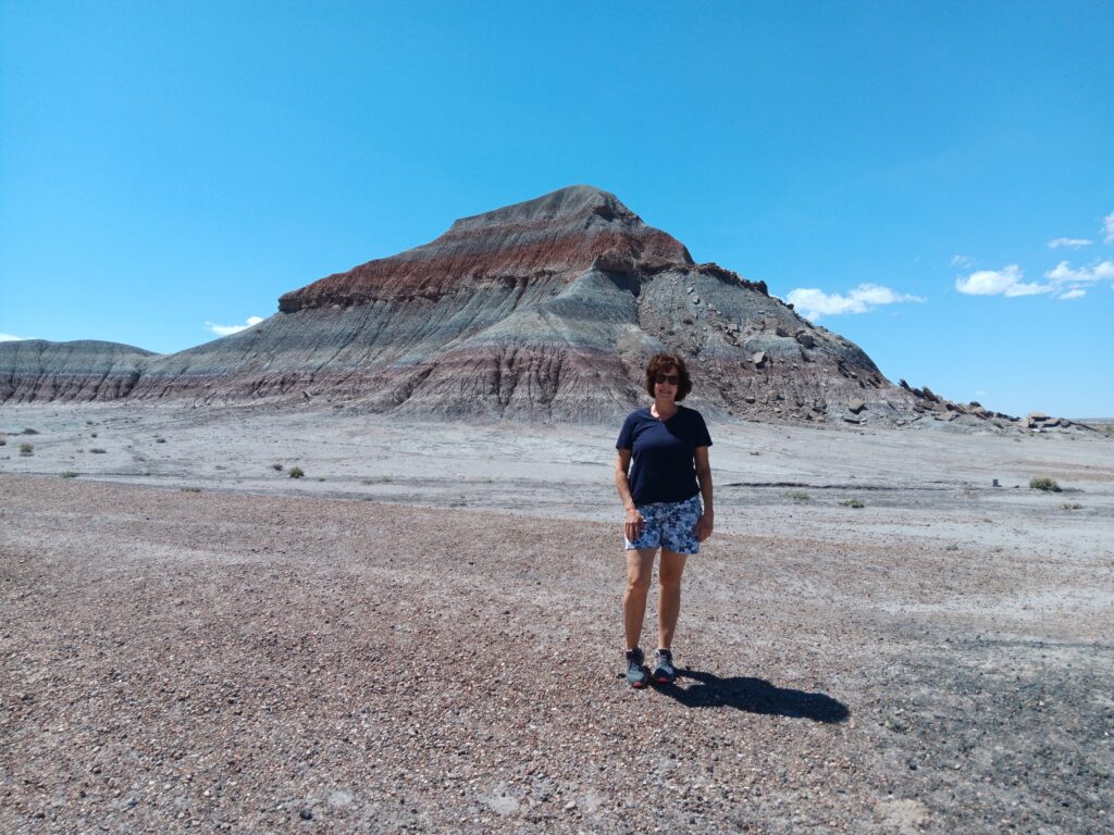 Karen in front of Painted Desert Blue Mesa Teepees