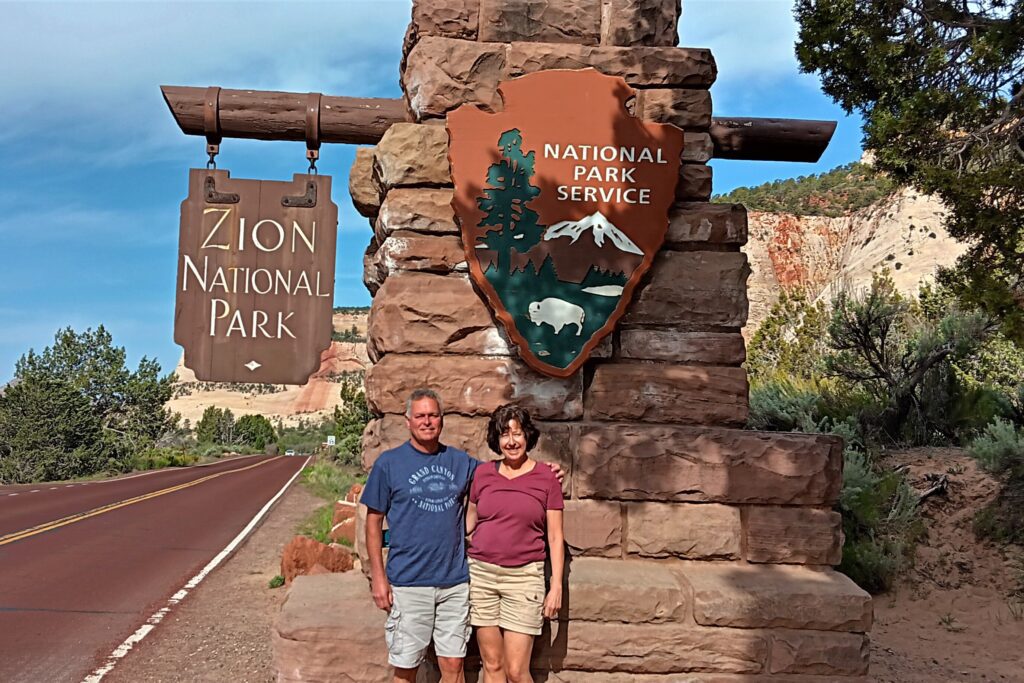 Karen and Steve at entrance sign for Zion National Park
